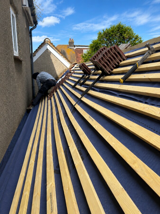 Roof being tiled over new membrane and battens