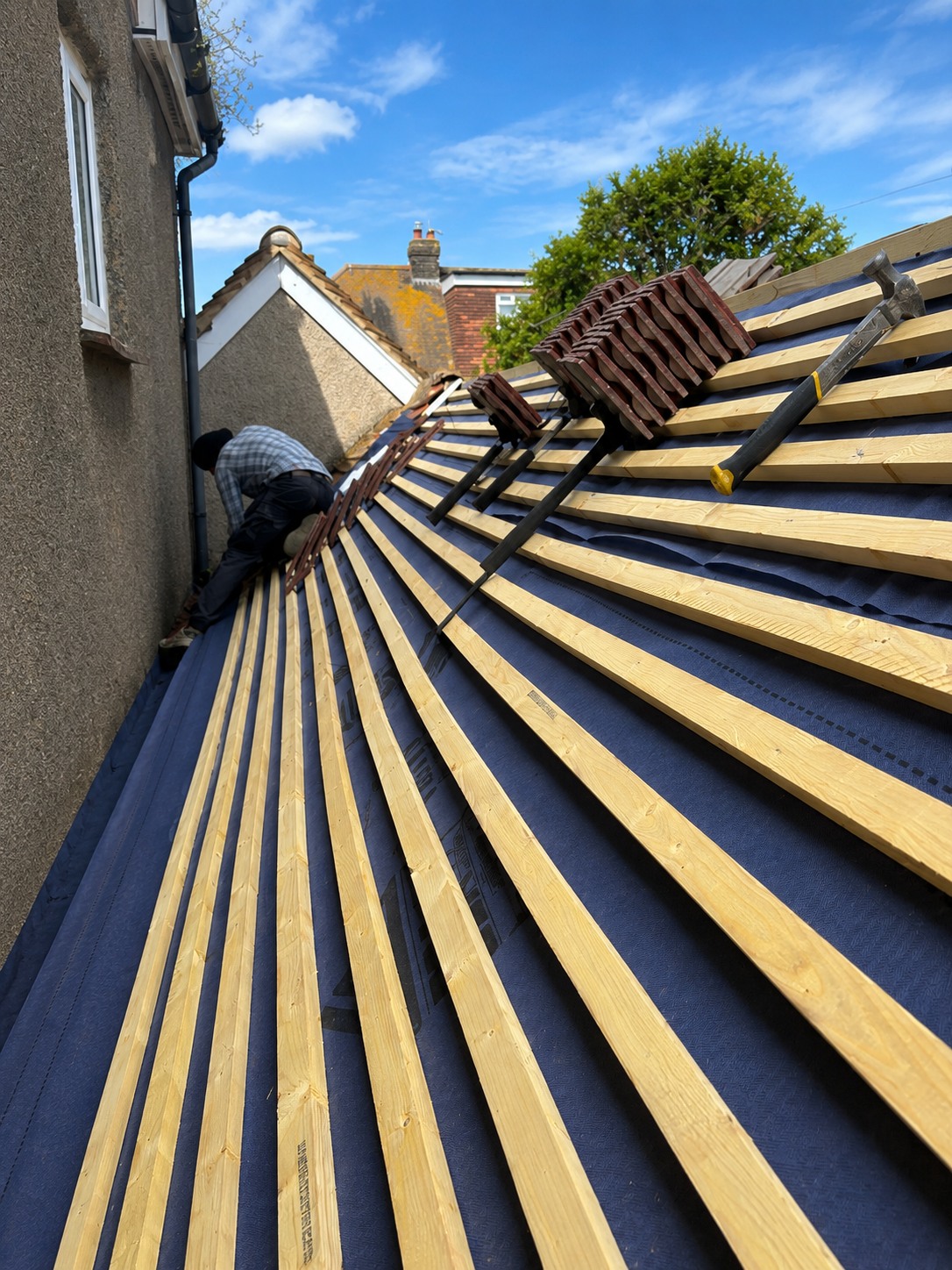 Roof being tiled over new membrane and battens