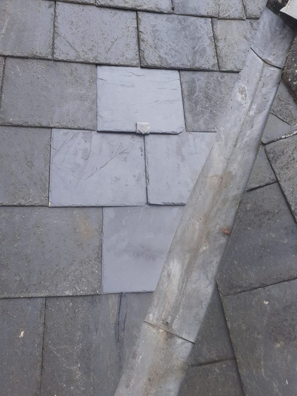 Close inspection view of slate and lead detailing
